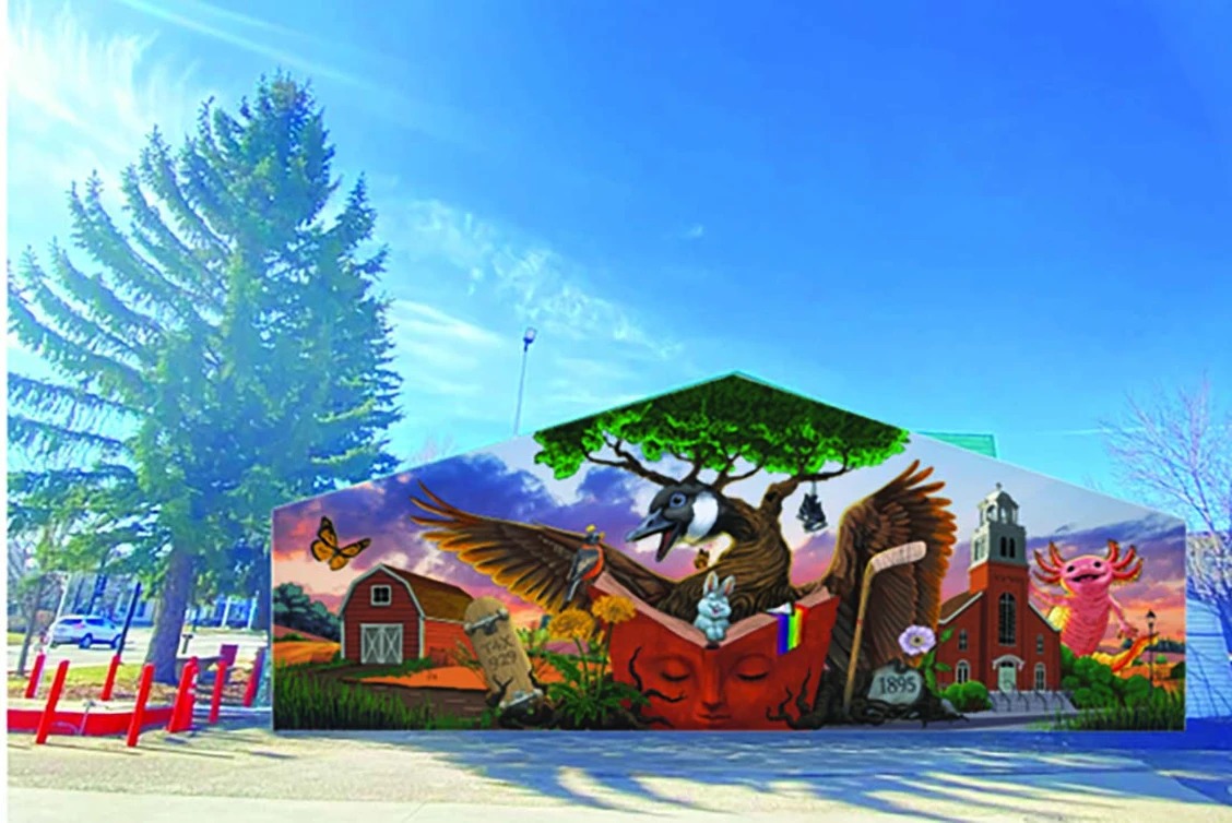 Rendering of a building-side mural featuring a large Canada goose with outstretched wings above an open book with a sleeping face, alongside a red barn, gravestone, brick church, rabbit, and pink axolotl.