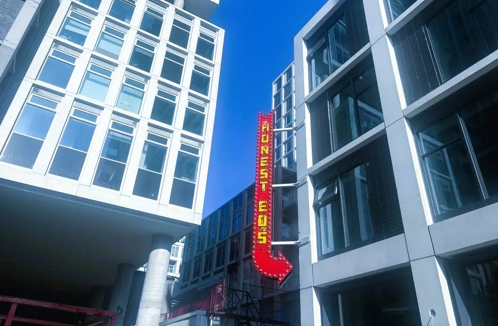 The sign against the buildings.