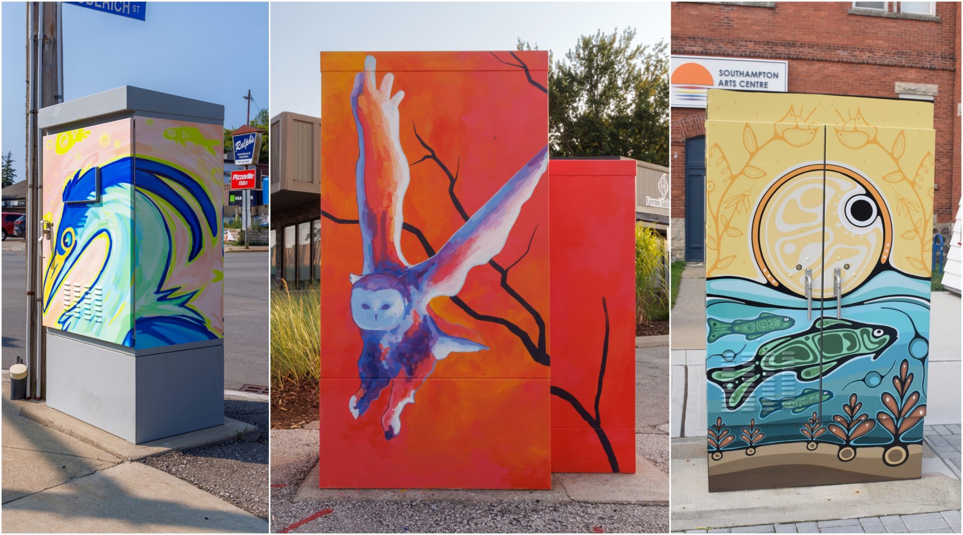 Three painted utility/traffic control boxes: a stylized blue heron on a street corner, a barn owl in flight against an orange background, and an Indigenous-style design of sun, water, and fish outside the Southampton Arts Centre.